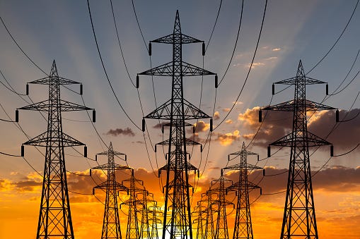 High voltage towers at sunset