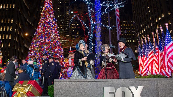 PHOTOS: Fox News lights up new Christmas tree after arson attack