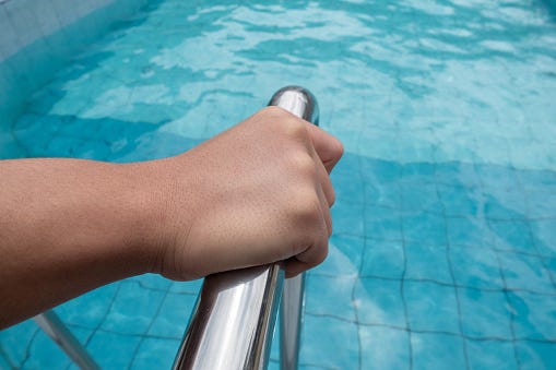 Hand on pool rail