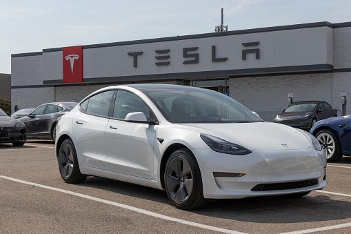 A Tesla awaits a buyer at a dealership.