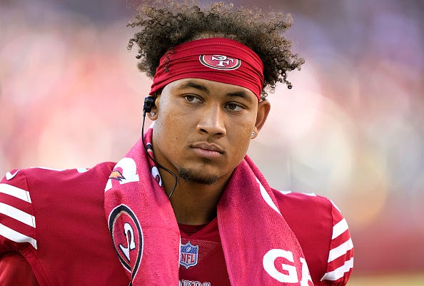 Trey Lance models the 49ers red uniform tops. 
