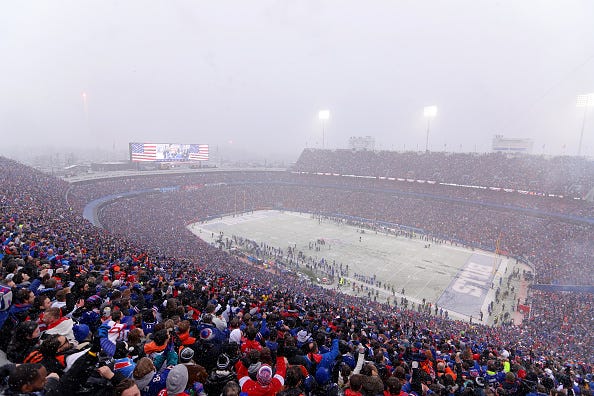 Fans cheer as snow falls during the first half in the AFC Divisional Playoff game between the Cincinnati Bengals and the Buffalo Bills at Highmark Stadium on January 22, 2023 in Orchard Park.