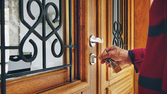 Man opening the front door of an Airbnb