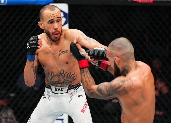 TORONTO, ONTARIO - JANUARY 20: (L-R) Sean Woodson punches Charles Jourdain of Canada in a featherweight bout during the UFC 297 event at Scotiabank Arena on January 20, 2024 in Toronto, Ontario.