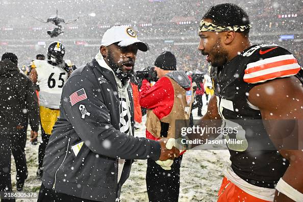 Head coach Mike Tomlin of the Pittsburgh Steelers congratulates defensive end Myles Garrett #95 of the Cleveland Browns after the game at Huntington Bank Field on November 21, 2024 in Cleveland, Ohio. The Browns defeated the Steelers 24-19