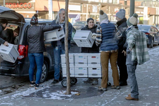 Members of the FBI supervise the removal of boxes and electronic equipment from Smart Therapy Centers business office in Minneapolis on Thursday, December 12, 2024. 