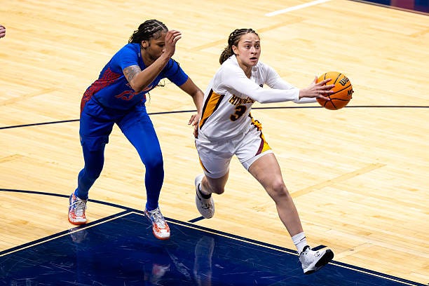 Amaya Battle #3 of the Minnesota Golden Gophers races to the basket while being defended by Laila Reynolds #13 of the Florida Gators during a semifinal game of the 2025 Women's Basketball Invitation Tournament.