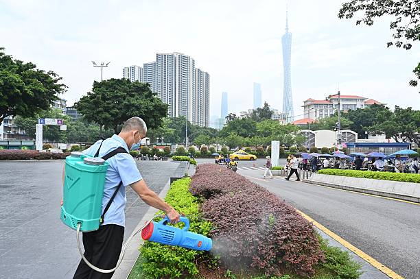 A staff member carries out mosquito eradication work on a green belt on July 30, 2025 in Guangzhou, Guangdong Province of China. China's Guangdong Province has launched targeted measures, including citywide cleanup efforts, to effectively curb the spread of Chikungunya fever, a mosquito-borne viral disease. 
