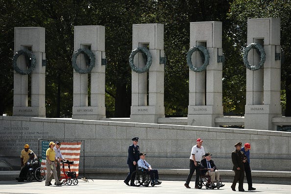 World War Two veterans make their way to a wreath laying ceremony at the National World War Two Memorial in Washington, D.C. 