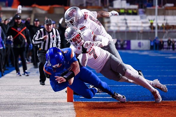 Maddux Madsen #4 of the Boise State Broncos dives for a touchdown against Jake Pope #7 of the UNLV Rebels at Albertsons Stadium on December 5, 2025 in Boise, Idaho.