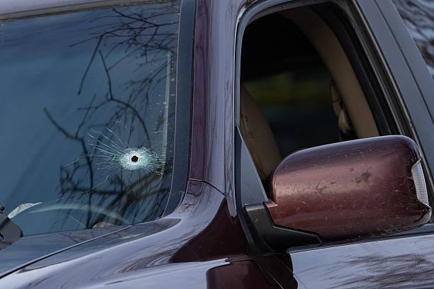 A single bullet hole can be seen on the driver's side of the windshield of a vehicle that a woman was shot and killed in by federal officers on Portland Ave. in Minneapolis, Minn. on Wednesday, January 7, 2026. Renee Nicole Good was shot and killed by an Immigration and Customs Enforcement (ICE) agent during a confrontation between federal agents and protesters in south Minneapolis earlier in the day. 