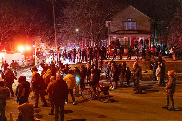 Residents confront federal agents following a shooting incident on January 14, 2026 in Minneapolis, Minnesota. According to reports, a federal agent shot a Venezuelan man who was resisting arrest. 