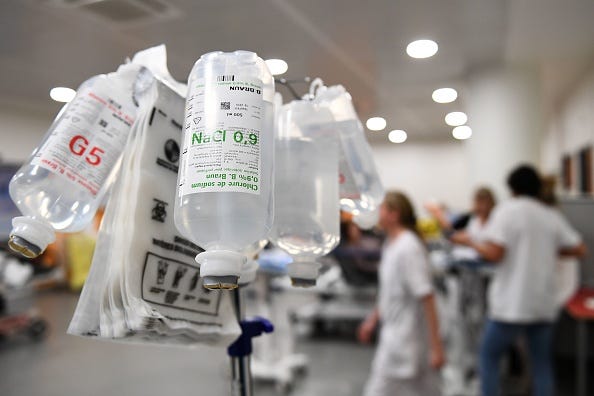 Bottles of IV fluid in a hospital emergency room