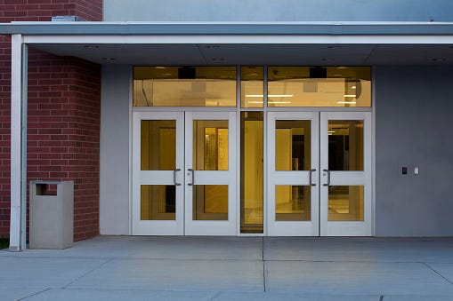 Glass and metal doors at a school's front entrance