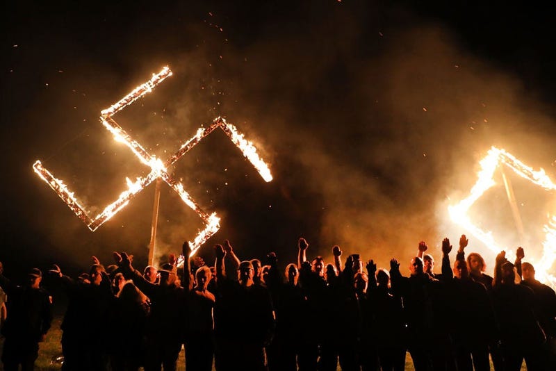 DRAKETOWN, GA - APRIL 21: Members of the National Socialist Movement, one of the largest neo-Nazi groups in the US, hold a swastika burning after a rally on April 21, 2018 in Draketown, Georgia. Community members had opposed the rally in Newnan and came o