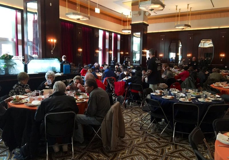Volunteers with Catholic Charities serve meals for their clients at Gibsons Steakhouse in River North.