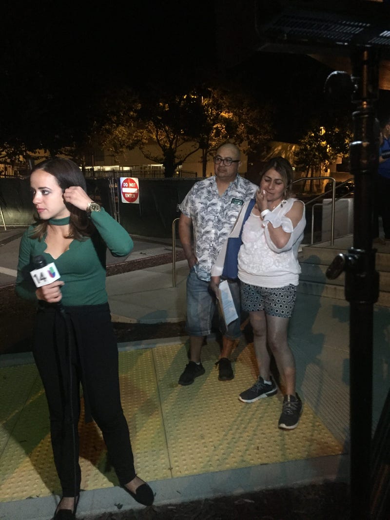 Parents wait outside of the emergency room at the Santa Clara Valley Medical Center where their 12-year-old daughter was being treated for a wound sustained at the Gilroy Garlic Festival shooting on July 28, 2019. 
