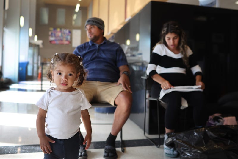 migrants at police station lobby in Chicago