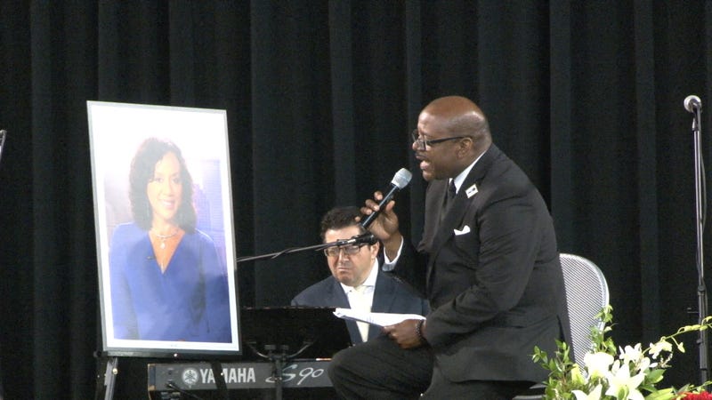 Glynn Boyd, husband of Nancy Parker, sings a song at her memorial service.