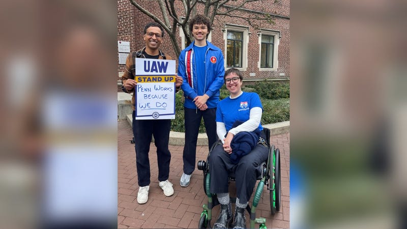 State Sen. Nikil Saval (left) protests with GETUP-UAW organizer Sam Shivar and another demonstrator.