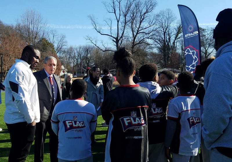 Grady Jarrett and Falcons Owner Arthur Blank chat with students at the newly renovated John F. Kennedy Park in Vine City.