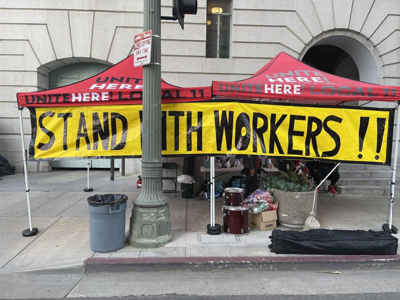 tents with sign that says stand with workers