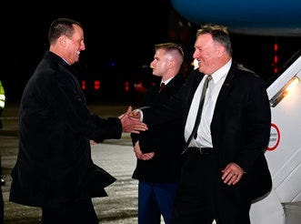 Secretary of State Mike Pompeo is greeted by U.S. ambassador to Germany Richard Grenell as he arrives at Munich International Airport, in Munich, Germany on Thursday, February 13, 2020. (Andrew Caballero-Reynolds/Pool via AP)