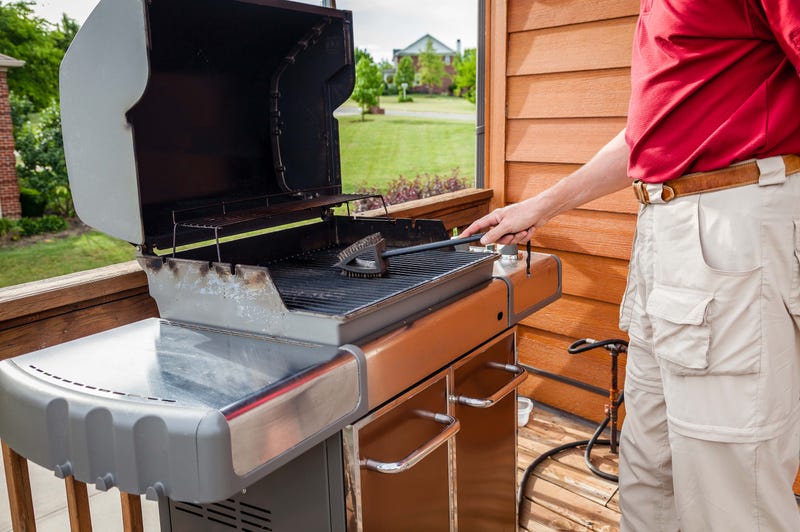 A man cleaning his grill