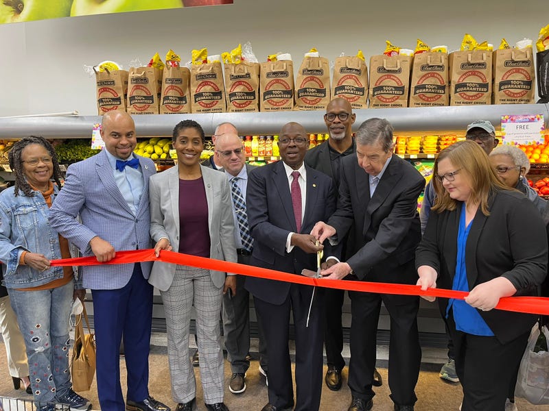 Dallas City Council member Tennell Atkins participates in the ribbon-cutting at a new grocery store in his district.