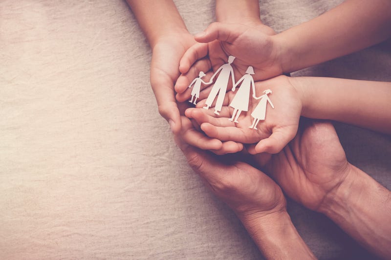 Adult and children hands holding paper family cutout, family home, adoption, foster care, homeless support, family mental health, domestic violence concept