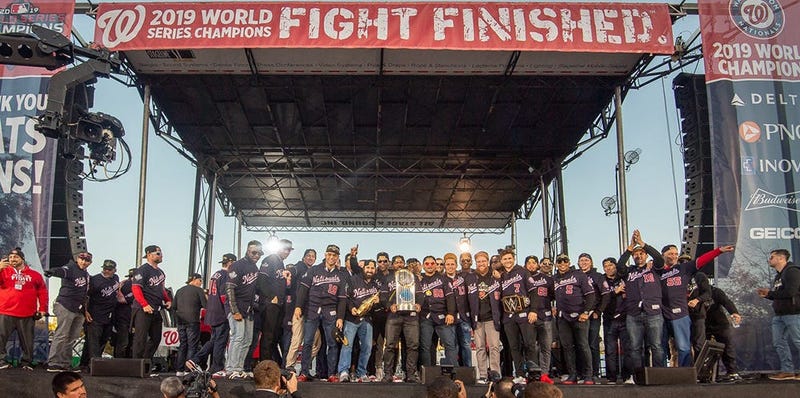 Washington Nationals players and coaches roll through the streets of Washington, D.C. and then speak on stage, celebrating their 2019 World Series championship with a few hundred thousand fans on November 2, 2019. 