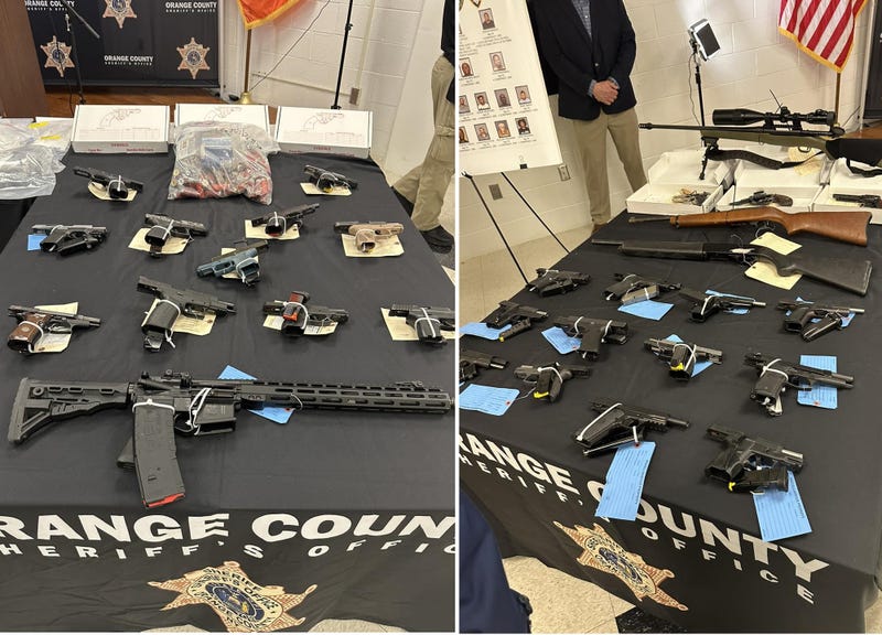 Guns seized as part of the operation are displayed by law enforcement