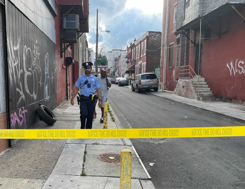 Police investigate the scene near Broad Street and Erie Avenue, where they say a 10-year-old boy accidentally shot himself to death.
