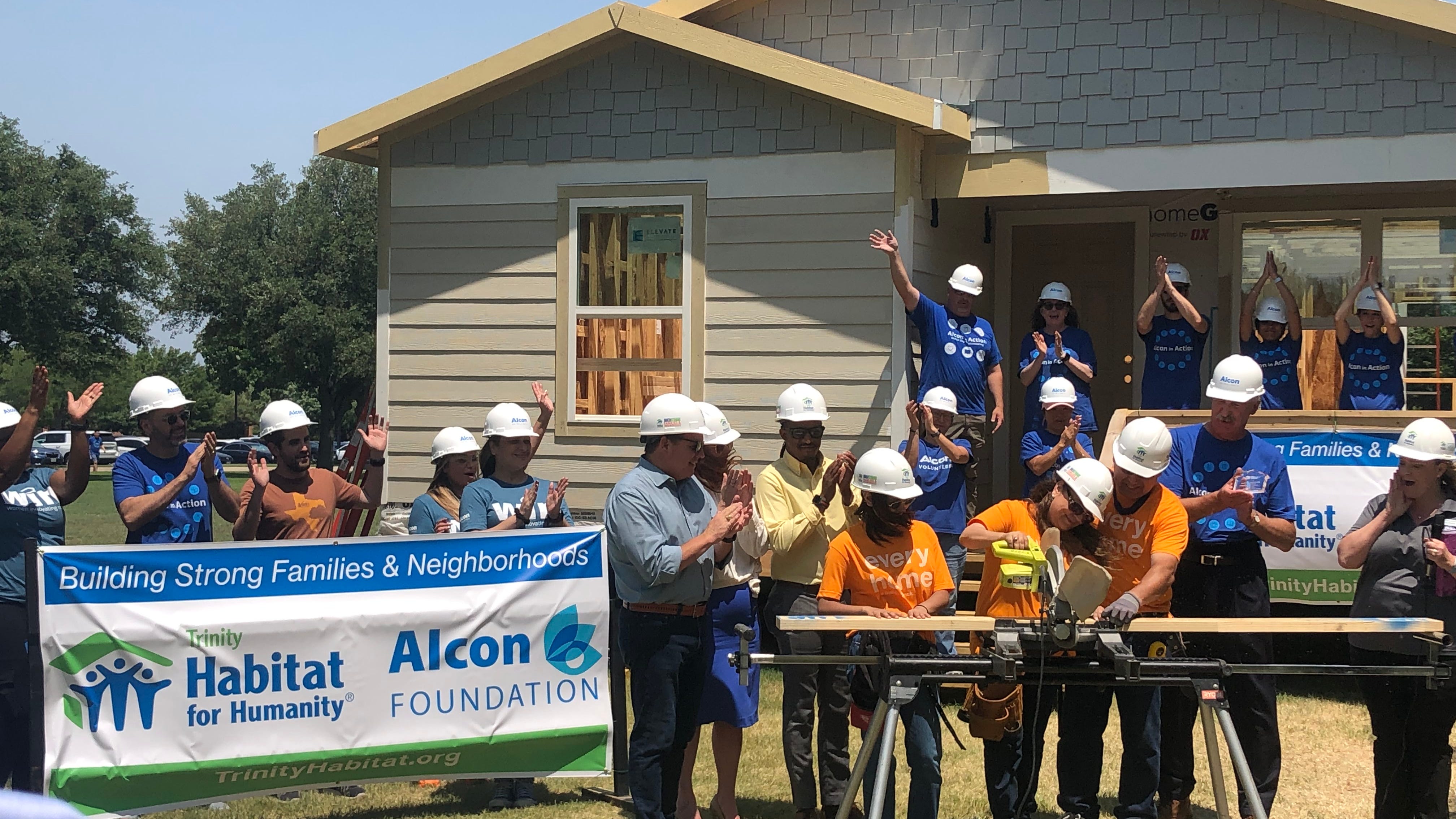 Habitat for Humanity, volunteers, family completing home in South Fort Worth