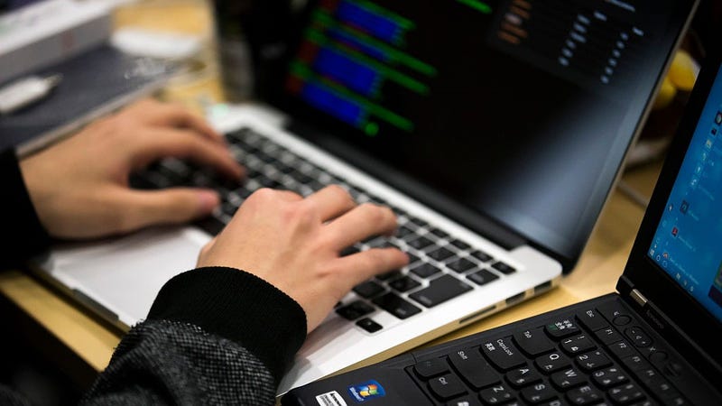 A participant uses a laptop computer as he takes part in the Seccon 2016 final competition on January 28, 2017 in Tokyo, Japan.