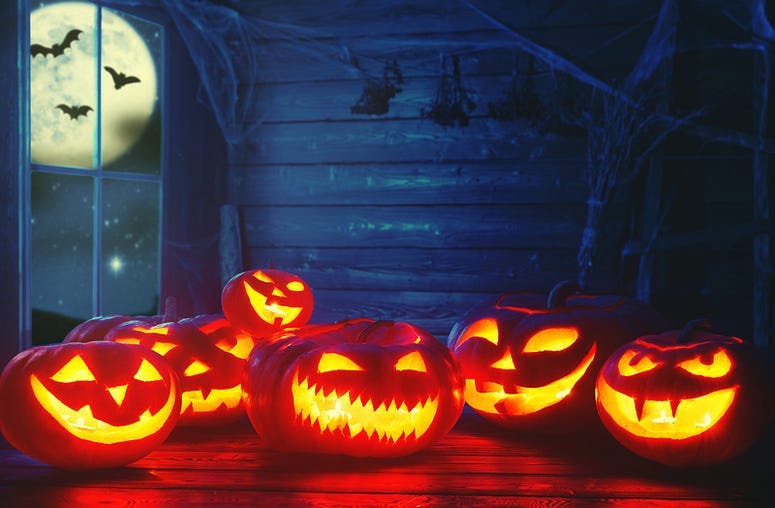 Spooky halloween background. scary pumpkin with burning eyes