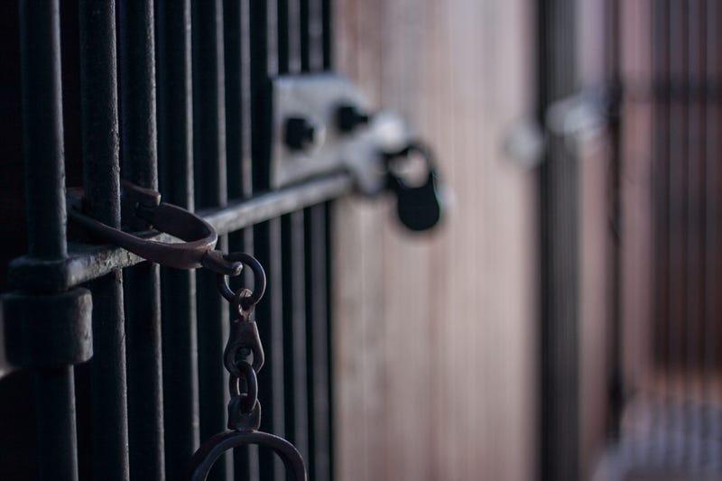 Handcuffs in abandoned jail with bars