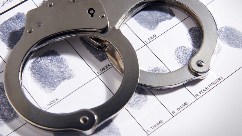 Handcuffs laying on top of fingerprint chart in file