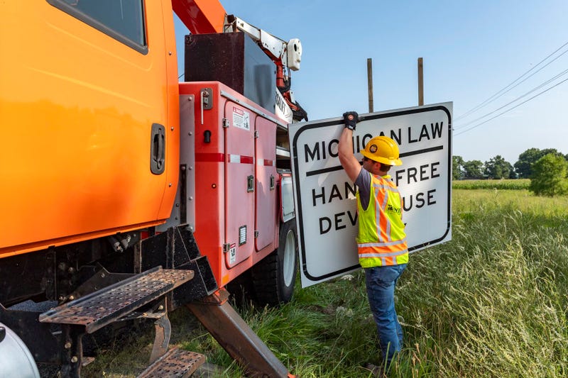hands free driving law signs going up