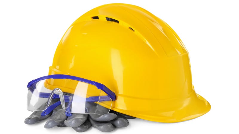 Hard hat, goggles and gloves isolated on white