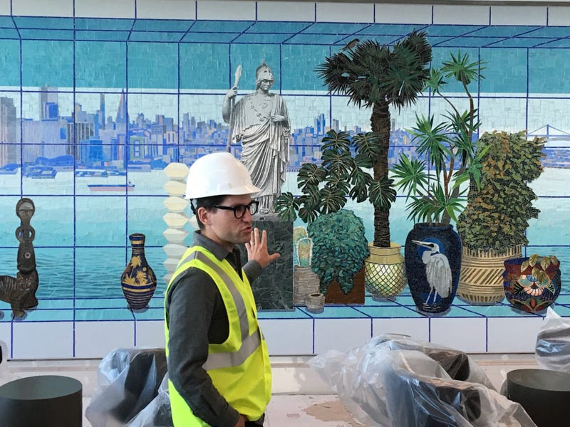 Artist Robert Minervini displays his work during a preview of the new Harvey Milk terminal at San Francisco International Airport.
