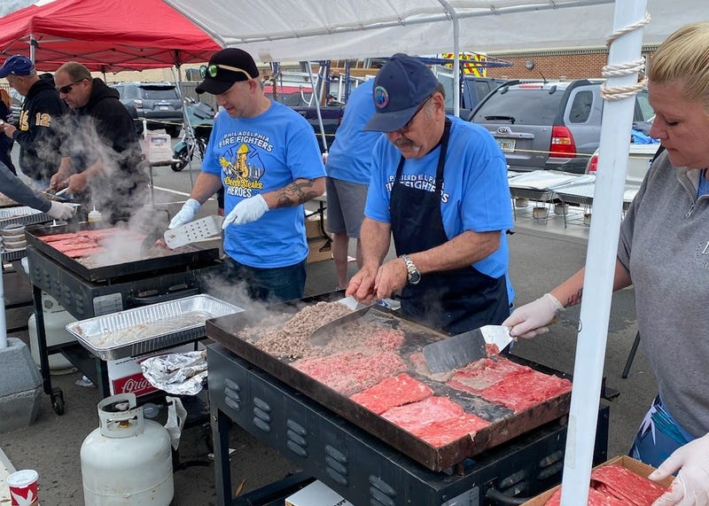 Police officers and firefighters take to the grill to raise money for the families of fallen firefighters and officers.