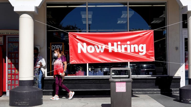 A Now Hiring sign hangs in front of a Winn-Dixie grocery store on December 03, 2021 in Miami, Florida.