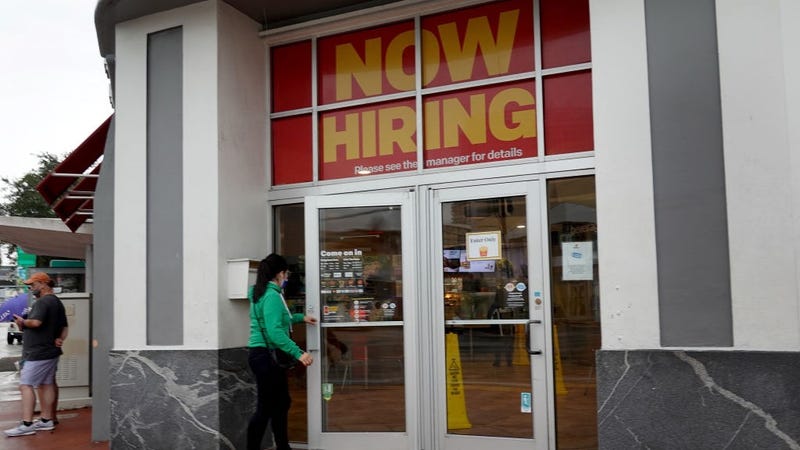  A ''Now Hiring" sign hangs above the entrance to a McDonald's restaurant on November 05, 2021 in Miami Beach, Florida. 