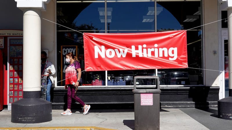  A Now Hiring sign hangs in front of a Winn-Dixie grocery store on December 03, 2021 in Miami, Florida.