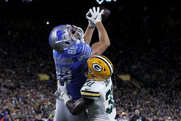 Lions TE TJ Hockenson jumps for a ball against the Packers. 