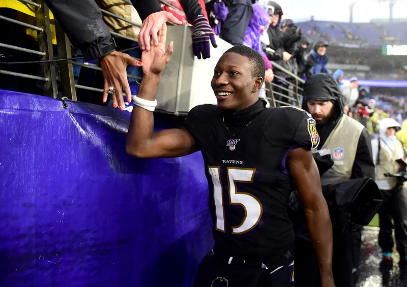 Ravens WR Marquise Brown celebrates with fans after a victory. 