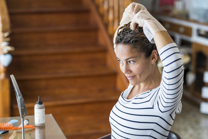 Woman coloring her hair at home