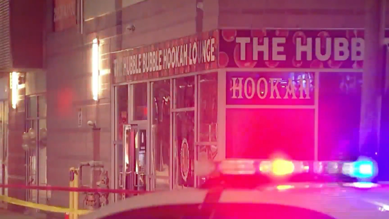 Police outside of the Hubble Bubble Hookah Lounge near Temple University's campus, on March 19, 2023.