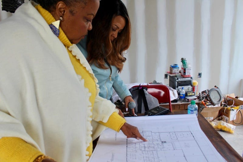 Elisabeth Omilami goes over floor plans for the new Hosea Helps facility in southwest Atlanta